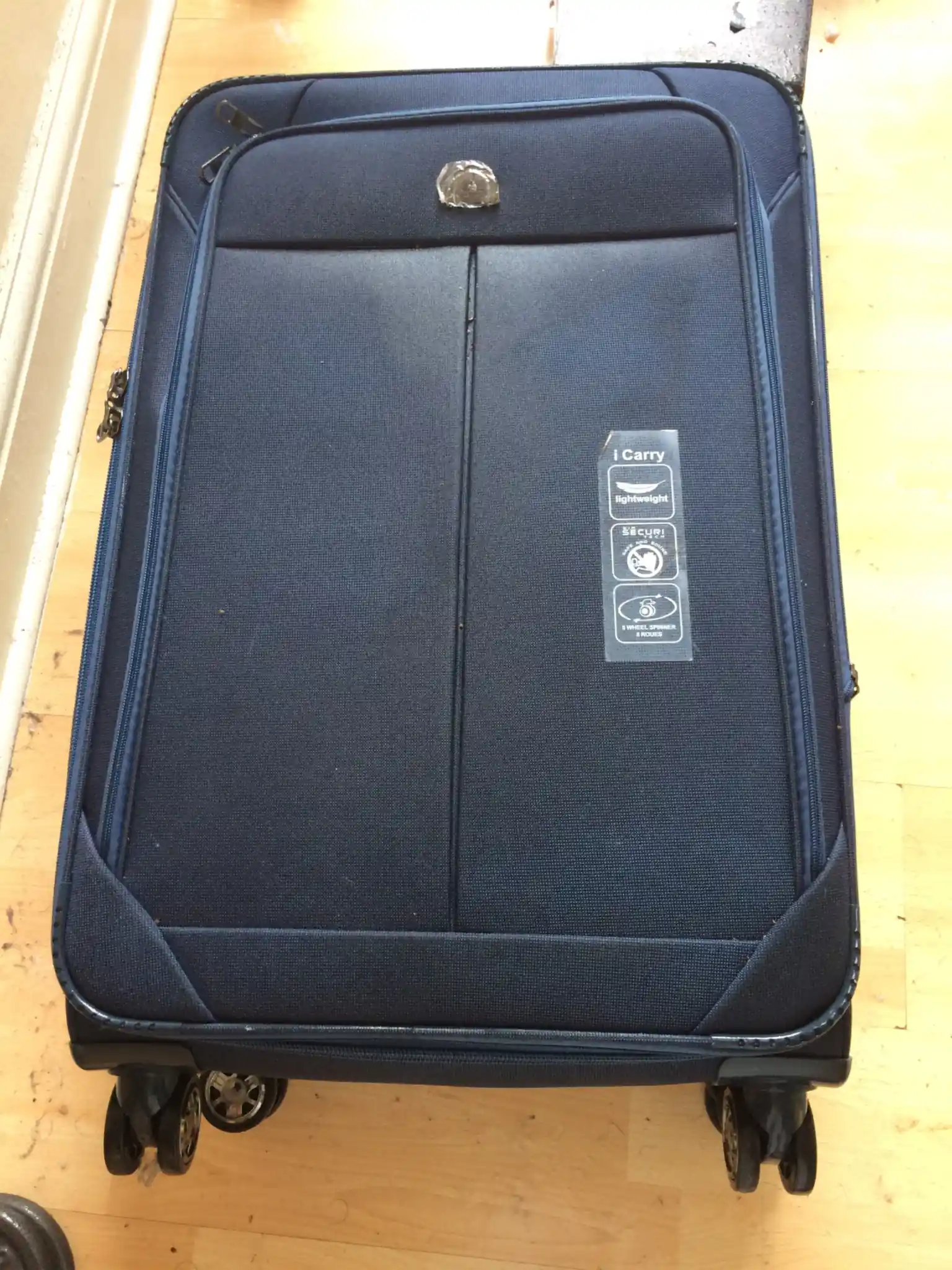Suitcase on a hard floor — keep luggage away from beds to prevent bed bug hitchhikers