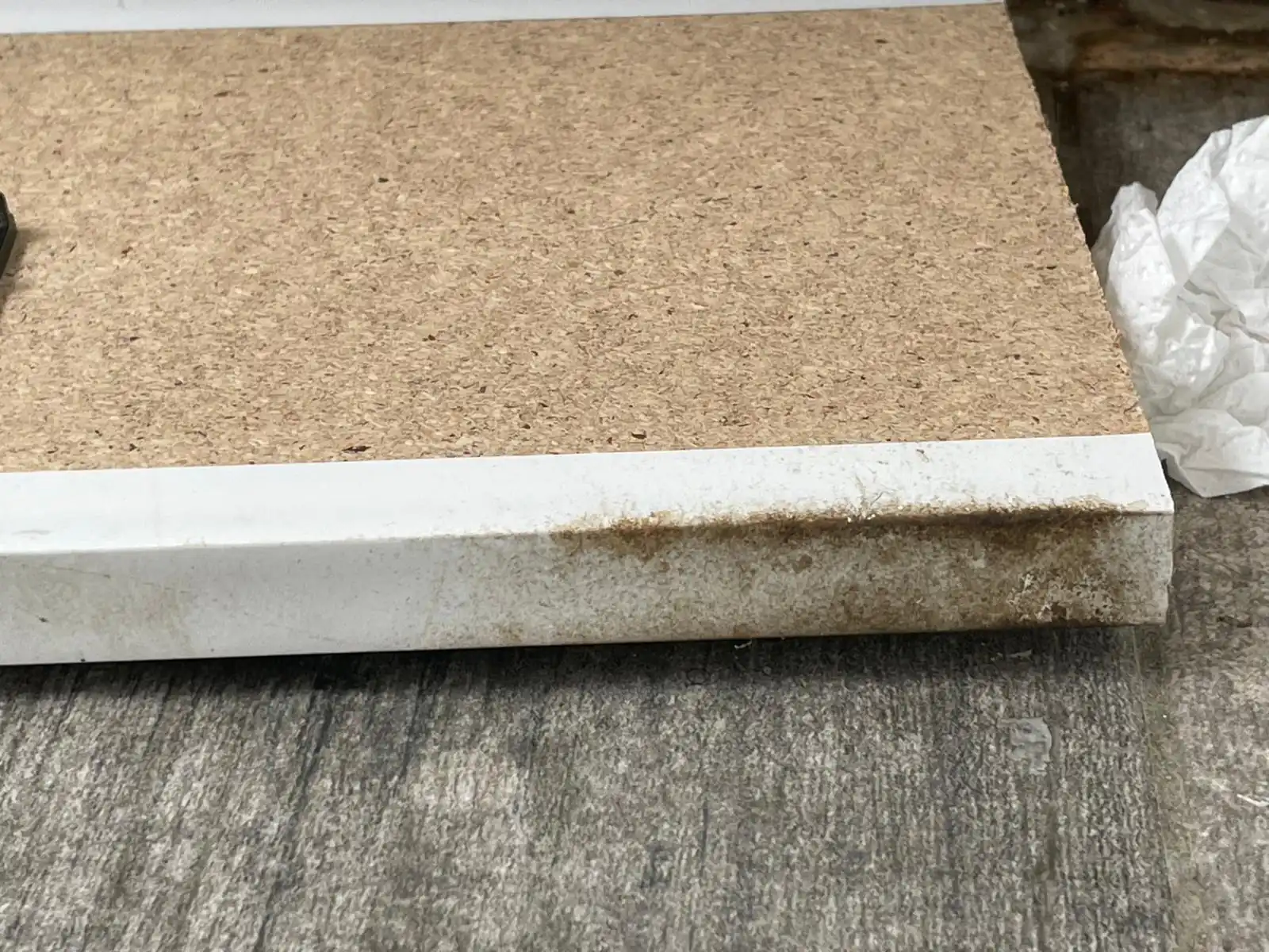 Grease smear marks left by mice along a skirting board and wall corner