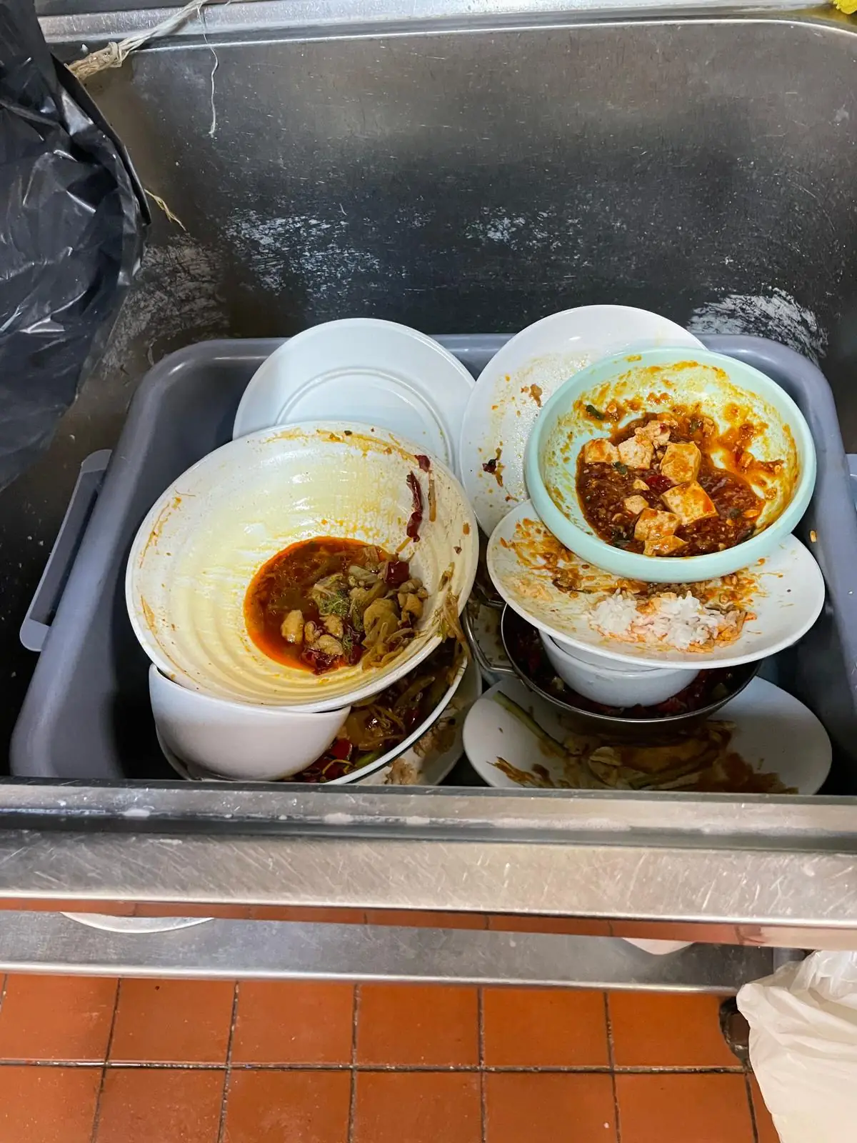 Overflowing commercial bins with food waste that attracts rats to business premises